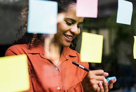 Business woman brainstorming with Post-it notes