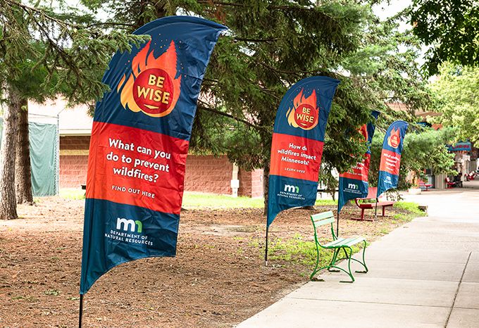 Feather banners lining the edge of the DNR Fire Prevention area at the Minnesota State Fair