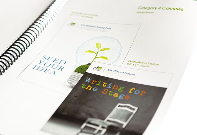 Detail of a brand guidelines document for Arts Midwest showing brochure covers