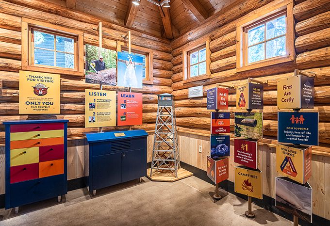 Interior of the DNR Fire Prevention Building at the Minnesota State Fair with interactive panels, a listening station, and prize drawers